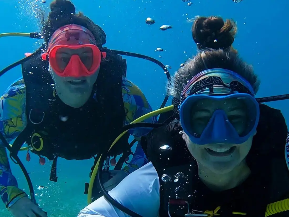 Mariya and Sam underwater in dive masks