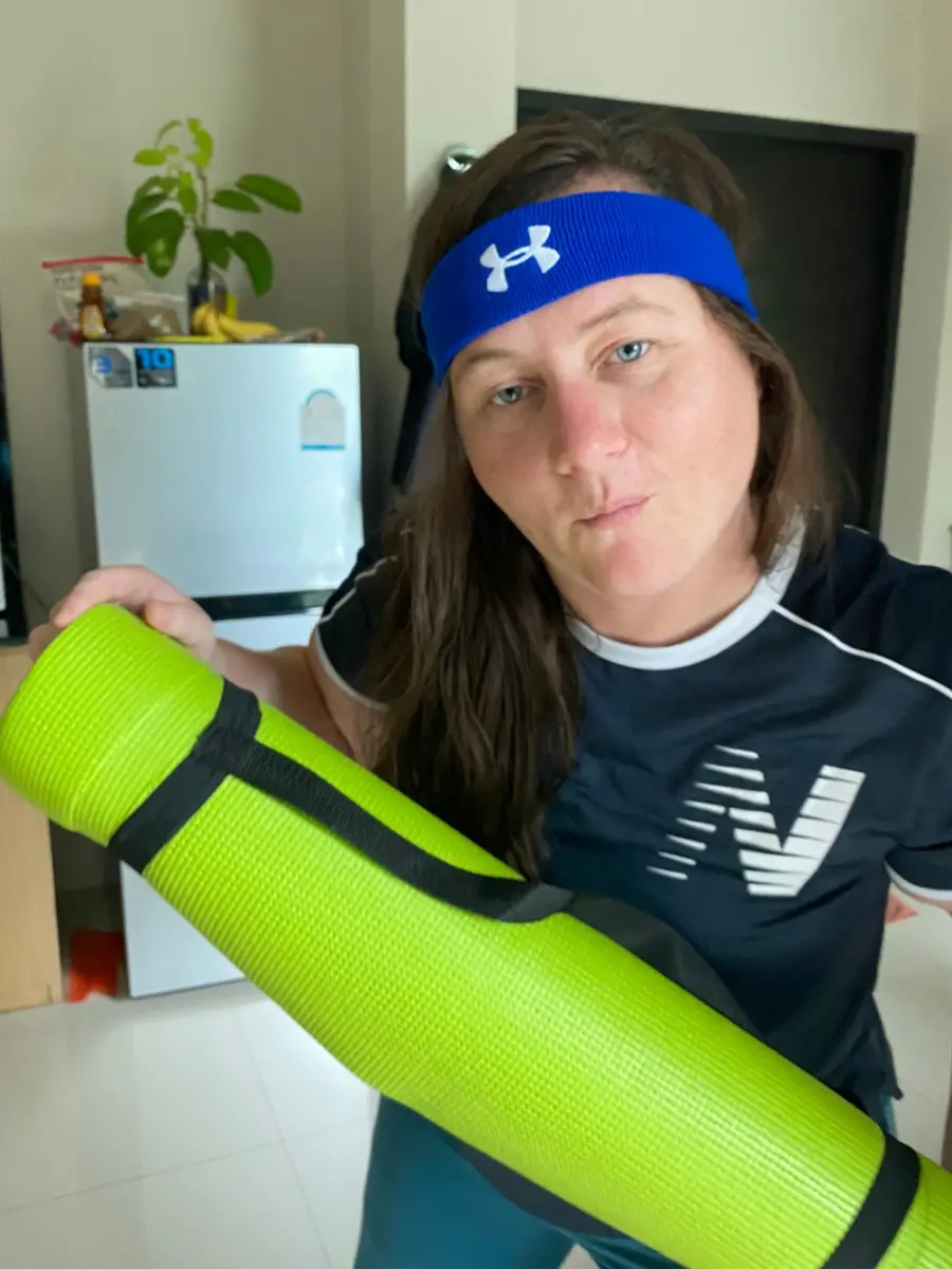 Mariya Pallais in a wetsuit holding a dive cylinder