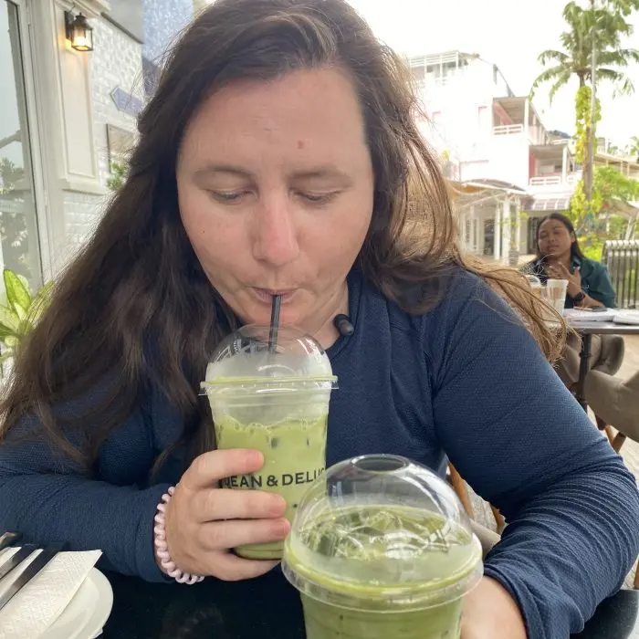 Mariya drinking an iced matcha at a cafe
