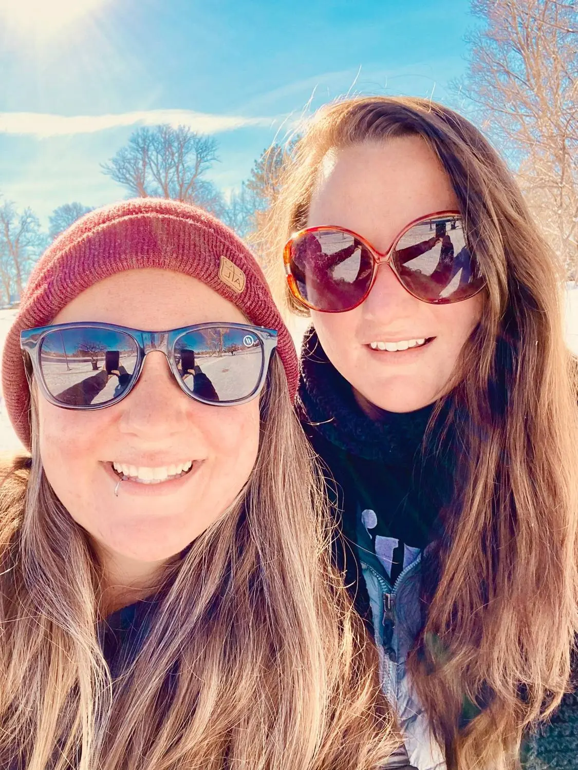 Mariya and Sam taking a selfie in sunglasses on a bright winter day